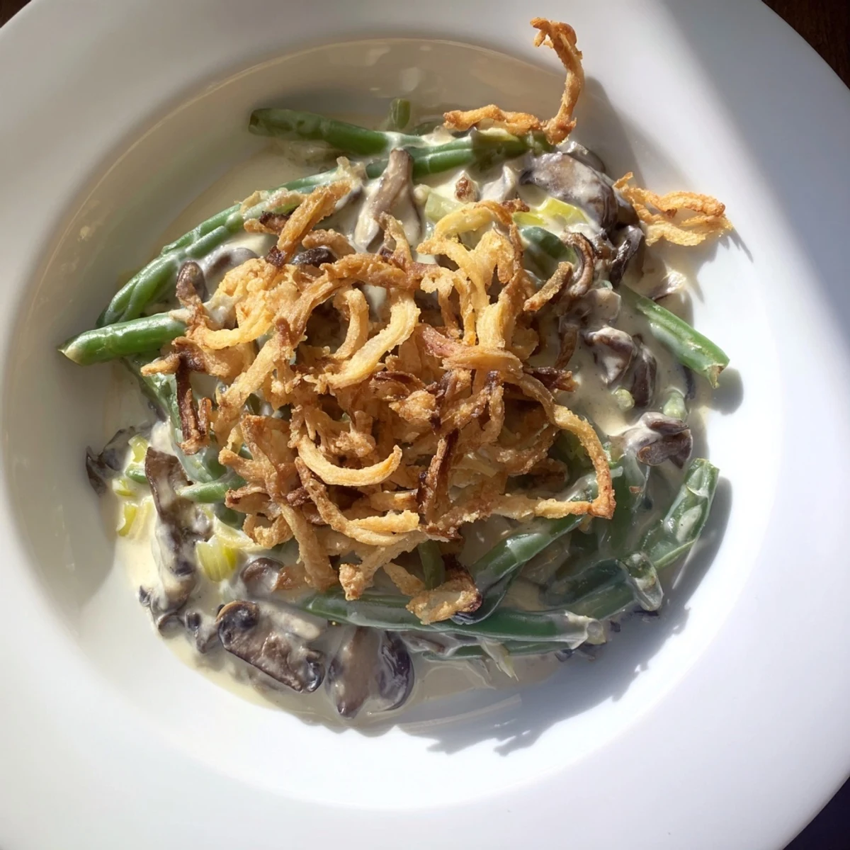 Golden-brown, bubbly Old-School Green Bean Casserole with crispy onions, a comforting classic side dish.