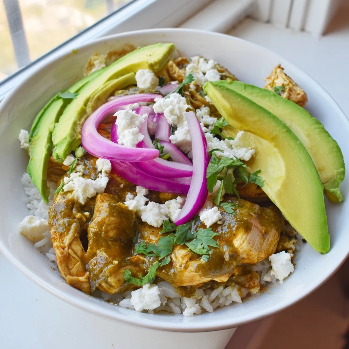 Vibrant Green Enchilada Rice Bowl, showcasing saucy chicken, fluffy rice, and fresh, colorful toppings, ready to eat.