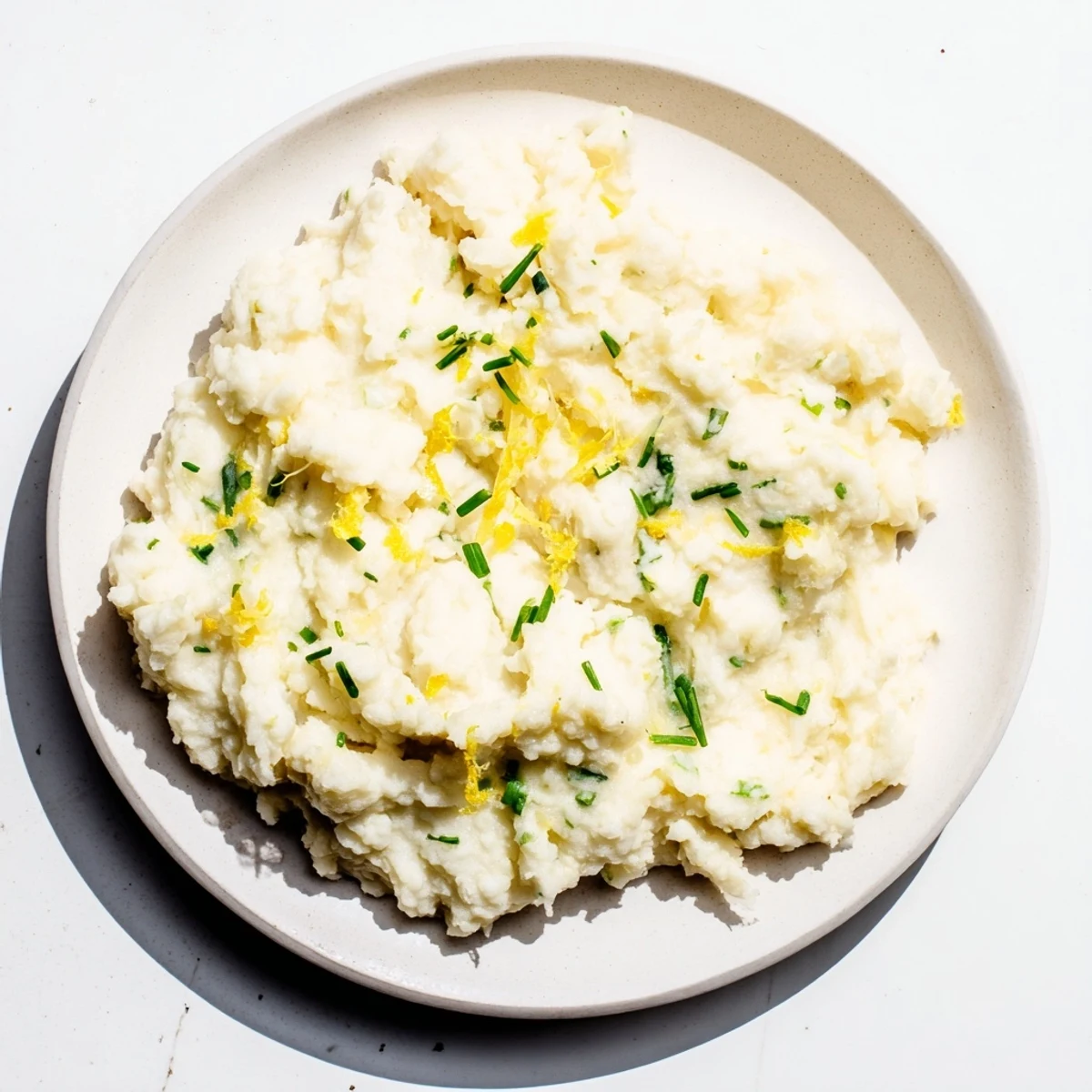 Fluffy and smooth, this cauliflower mash recipe offers garlic and lemon flavors, delicious.