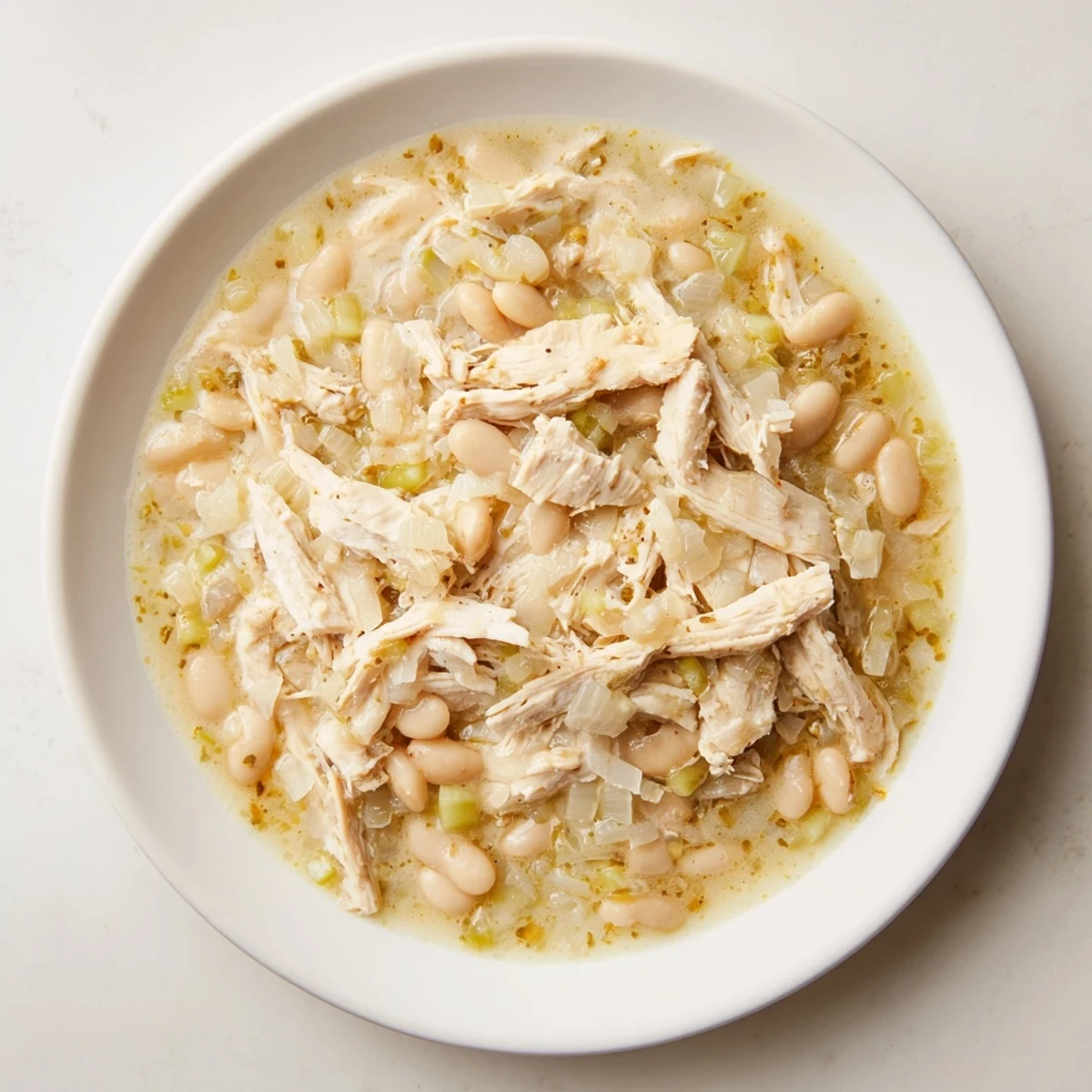 A close-up view of creamy 35-Minute White Cheddar Apple Chicken Chili, perfectly garnished and ready to be served.
