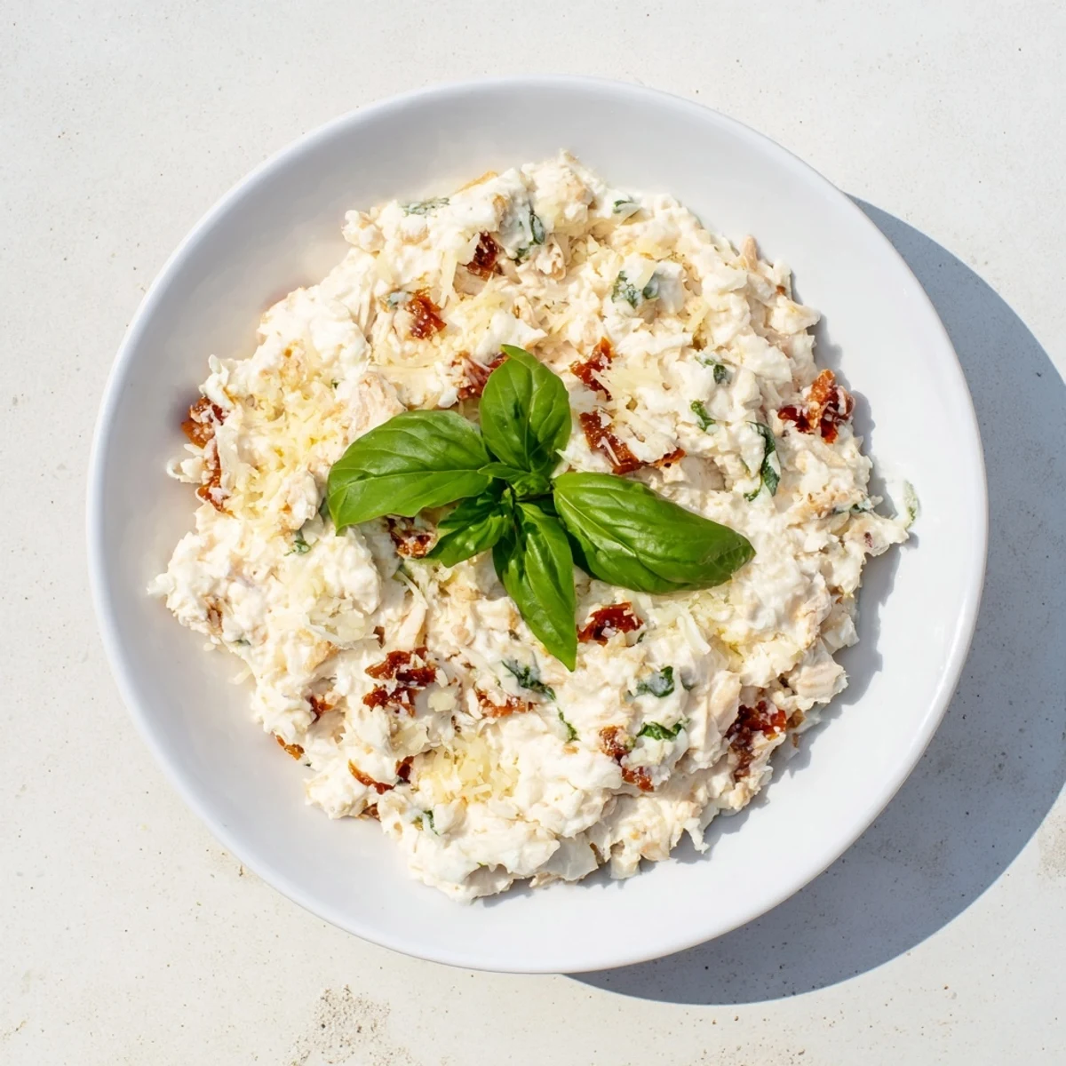 Creamy Lightened Marry Me Chicken Dip, bubbly and golden, served with colorful veggie sticks.