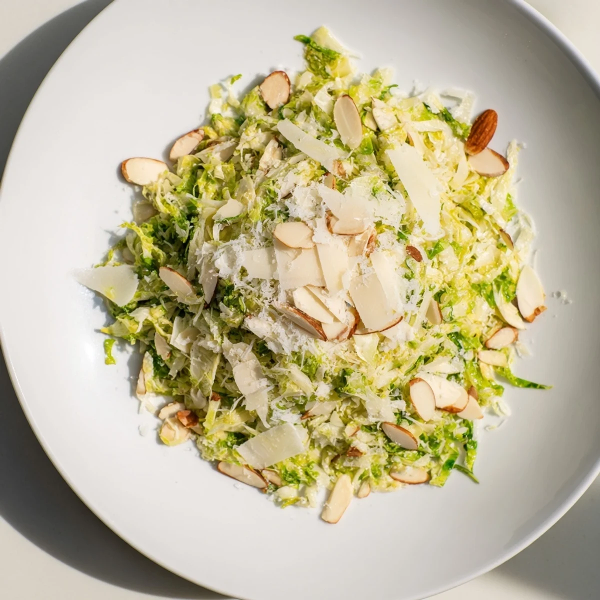 Fresh Crunchy Lemon Parmesan Brussels Sprouts Salad, a bright, inviting salad with toasted almonds.