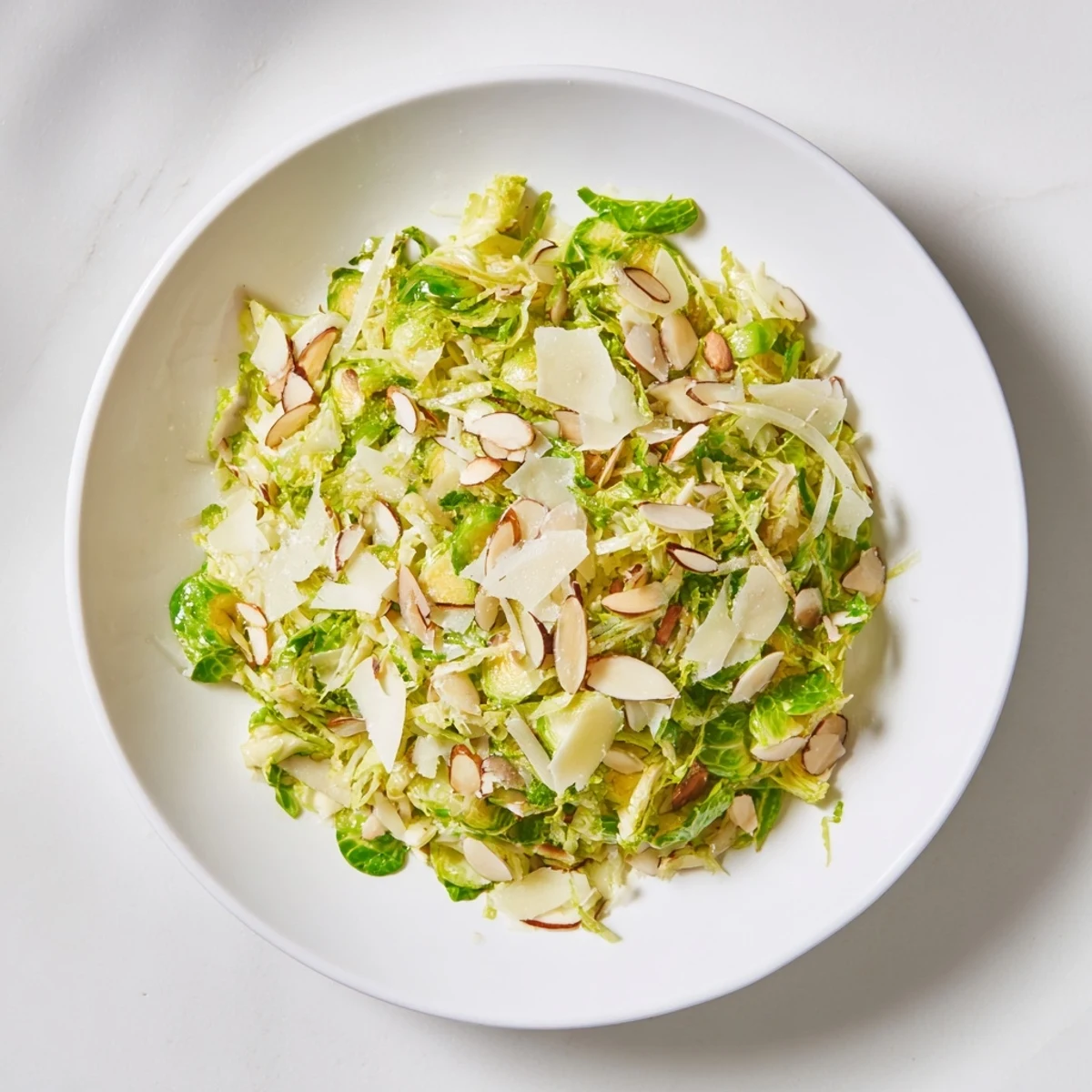 Tossed and ready: this zesty Crunchy Lemon Parmesan Brussels Sprouts Salad features crisp, shaved sprouts.