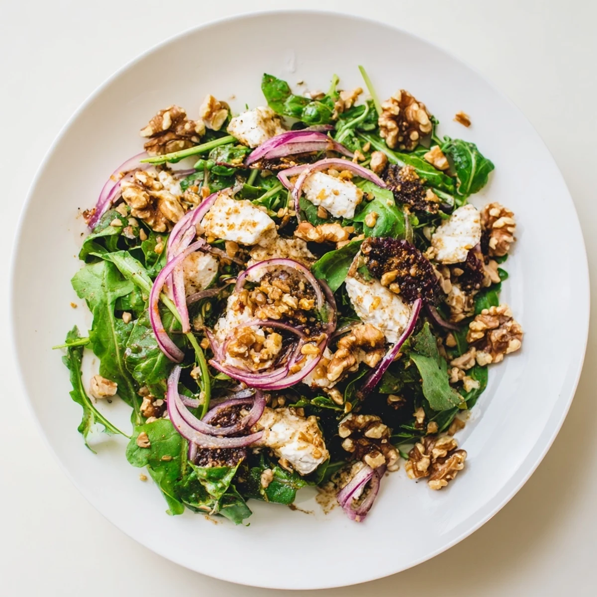 A colorful bowl of Spiced Honey and Date Goat Cheese Salad, perfect for a light vegetarian lunch.