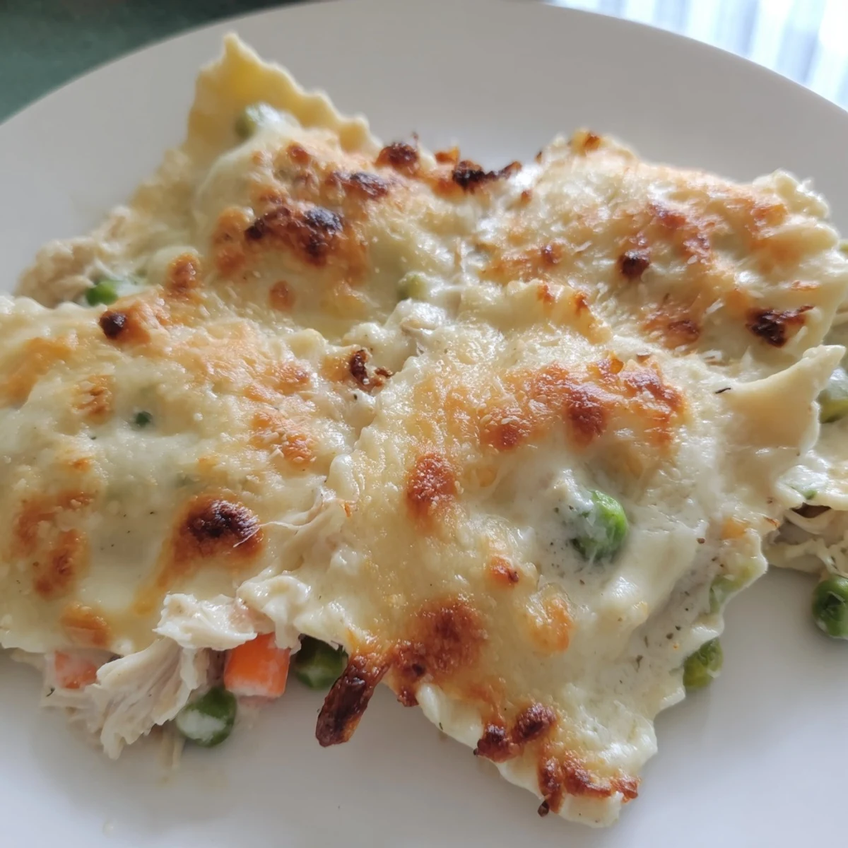 Creamy Chicken Pot Pie Ravioli Bake bubbling hot, offering comfort food with cheesy, golden perfection.