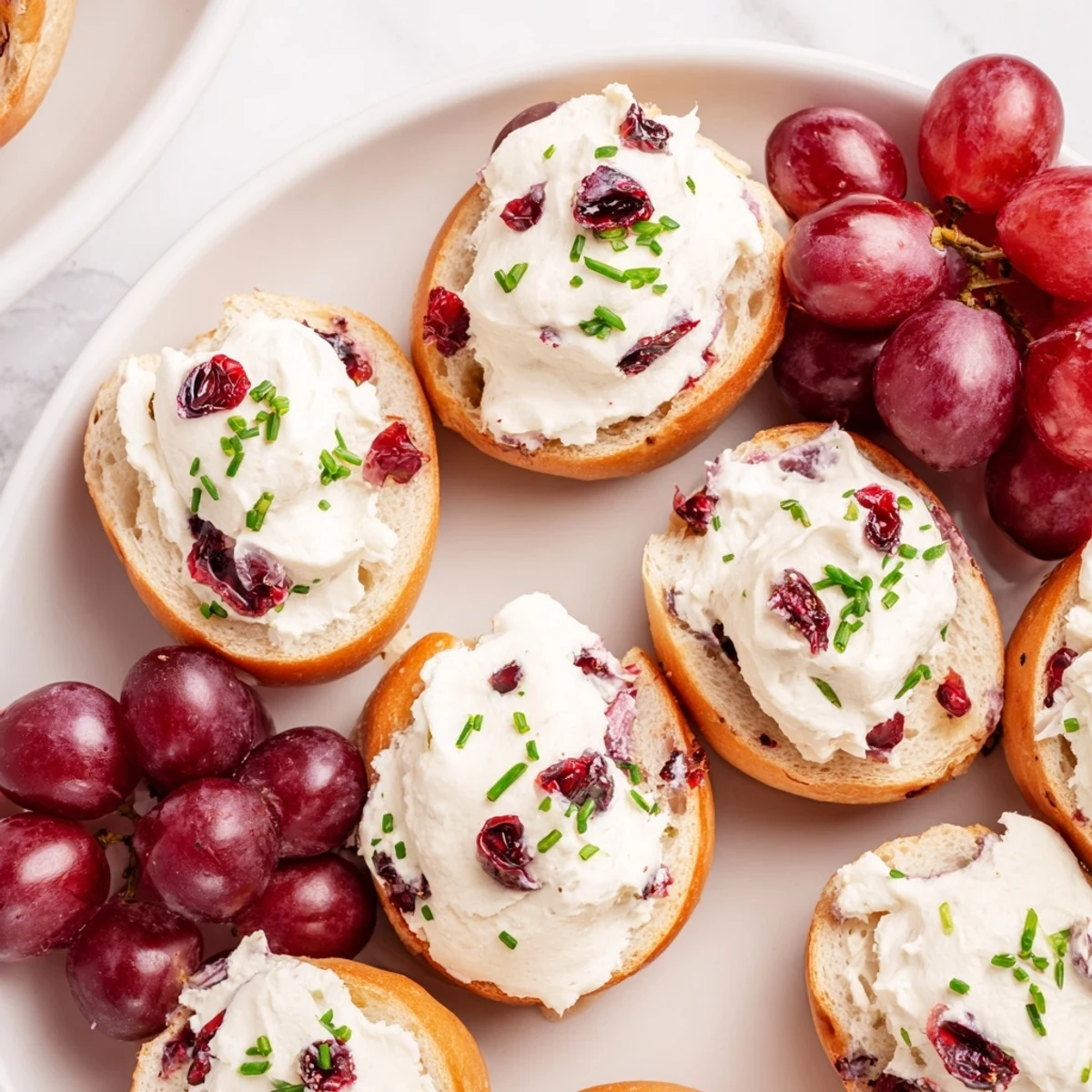 Festive cranberry sleigh bagel board, packed with colorful fruits and smoked salmon ready to serve.