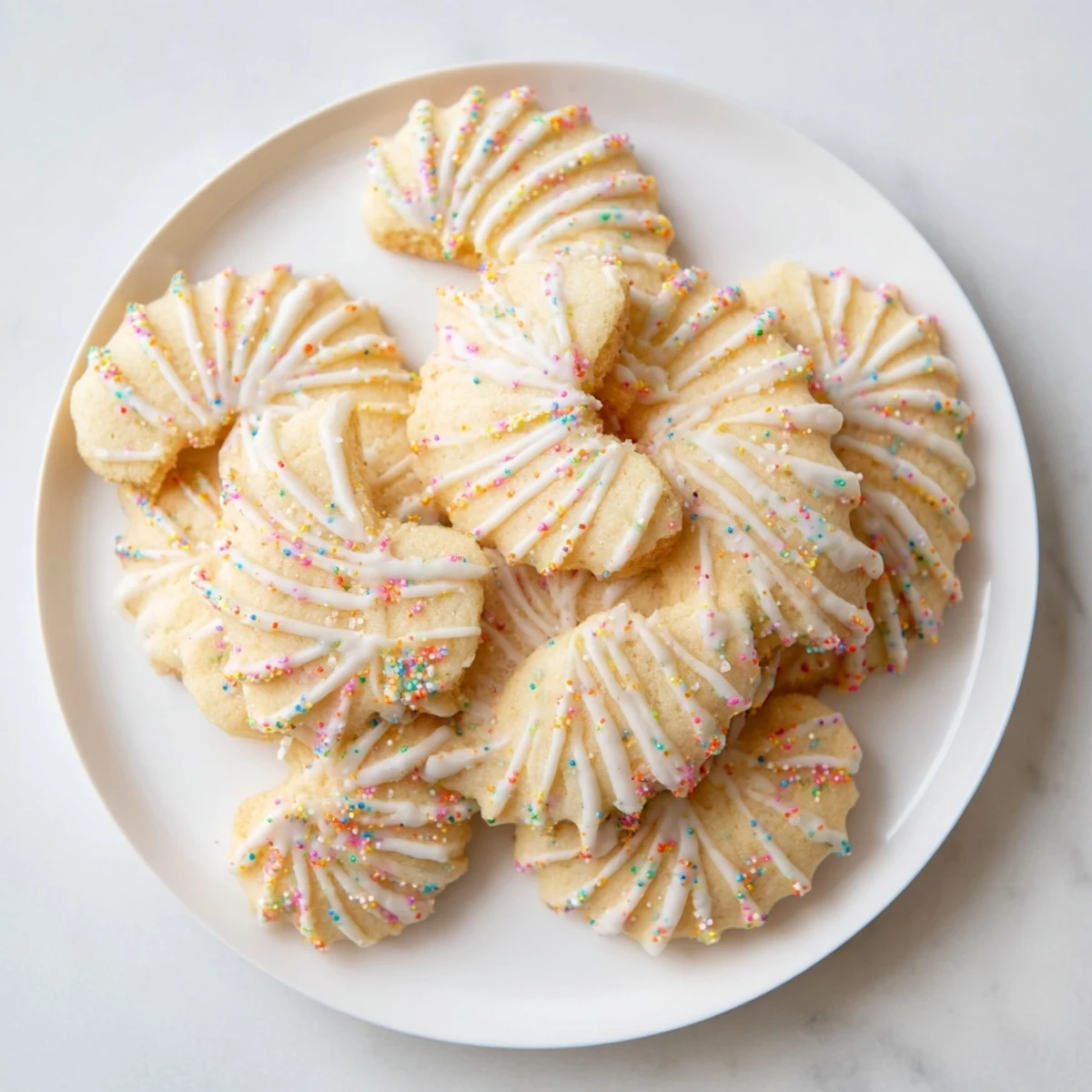 Spritz cookies arranged artfully in a layered fan, a festive treat sure to please everyone.