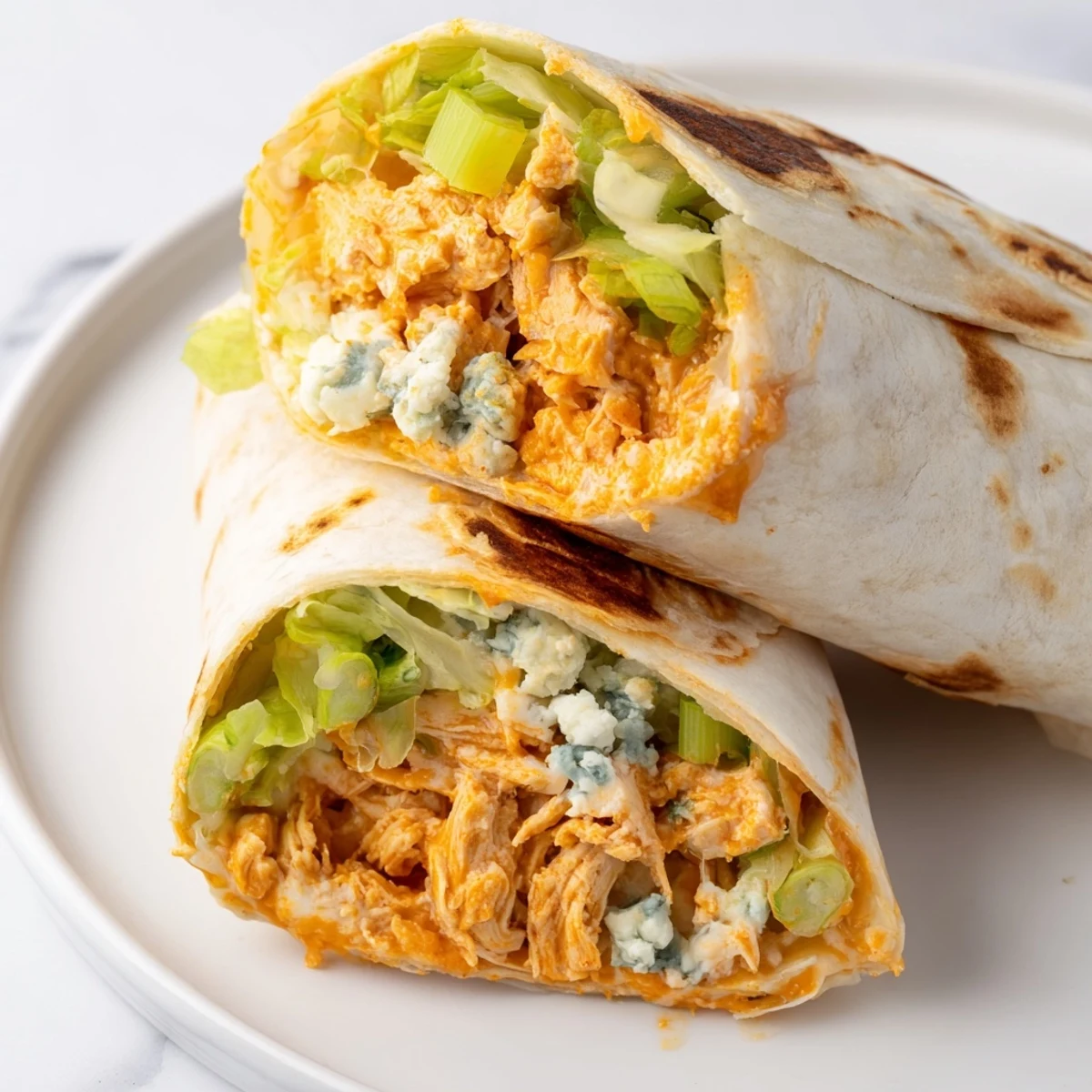 Steaming Buffalo Chicken Dip Wrap, with melted cheese and a vibrant, flavorful filling ready to eat.