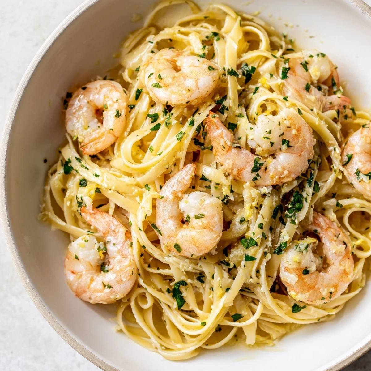 Zesty Lemon Herb Pasta with Shrimp, served in a pasta bowl with a wedge of lemon for a bright finish.