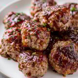 Close-up of baked mini meatloaf bites, a savory American classic bursting with flavor and texture.