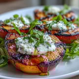 Juicy grilled peach and burrata salad drizzled with honey, perfect summer side dish.
