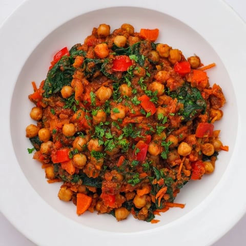 Steaming Vegetarian Chickpea & Spinach Skillet, vibrant and savory, ready to serve with crusty bread.