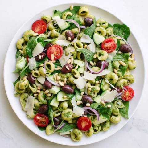 Creamy Caesar Pesto Ditalini Salad with vibrant tomatoes and fresh Parmesan, ready to enjoy.