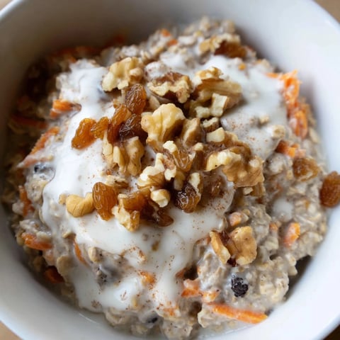 Creamy Carrot Cake Overnight Oats, layered with fresh carrots, spices, and nuts in a mason jar.