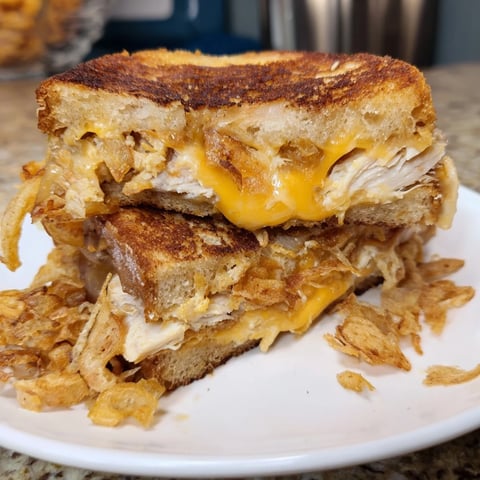 Crispy Shallot Chicken Grilled Cheese, golden brown and oozing cheese, perfect for a cozy lunch.