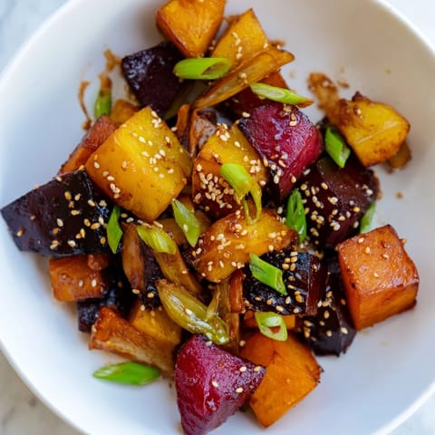 Vibrant image of caramelized Miso Roasted Winter Vegetables, glazed and glistening after roasting.