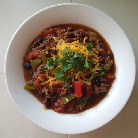 A close-up of a flavorful quick chili with canned beans, perfect for a cozy weeknight dinner.