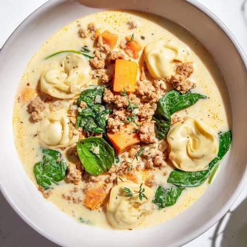 A close-up view of the rich, savory Creamy Sausage Tortellini Soup, perfect for a cozy dinner.