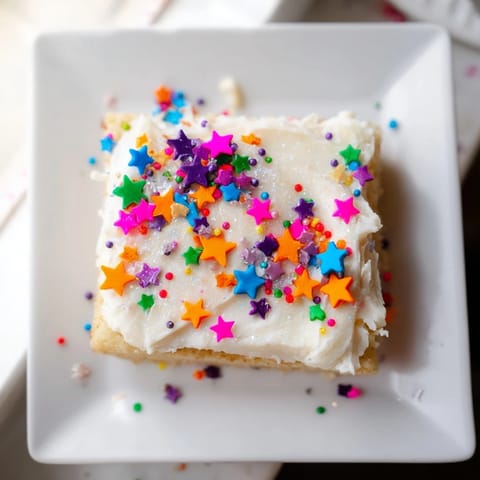 Golden, buttery Twinkle Twinkle Star Dessert Bars, frosted and sprinkled, ready to enjoy at any party.