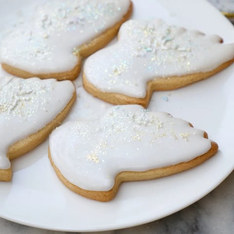 Buttery, crisp Angel Wings sugar cookies, artfully arranged on a plate with shimmering sprinkles.