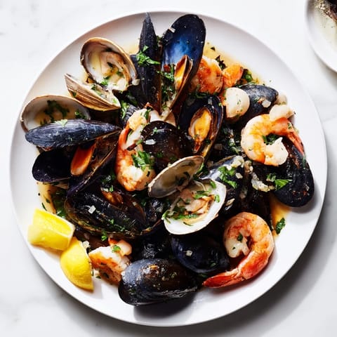 Freshly steamed Shellfish & Seafood Medley, with lemon wedges, is a delectable main course for seafood lovers.