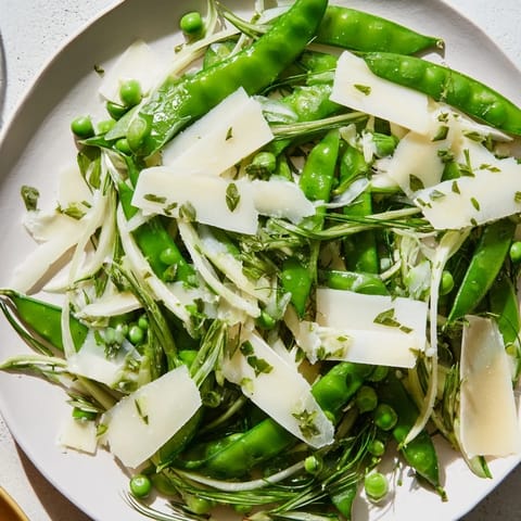 A close-up view of The English Ivy salad, showcasing cheese and a vibrant, fresh dressing.
