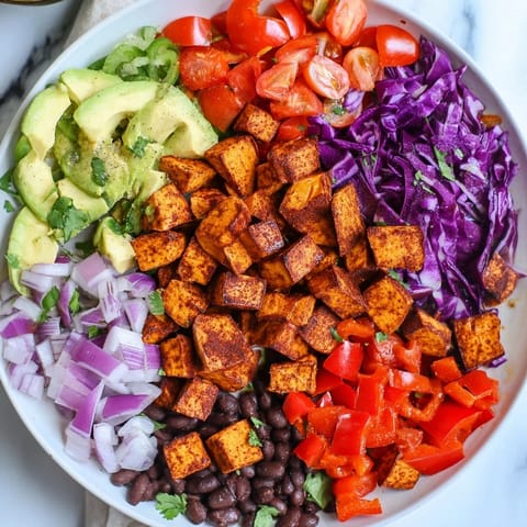 Vibrant image shows sweet potato taco bowls, with black beans, avocado, and lime, ready to enjoy.