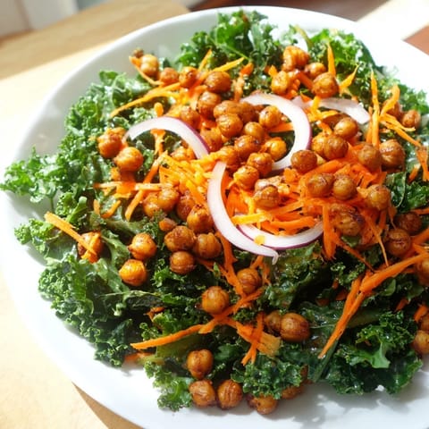 A close-up shot of the kale salad with roasted chickpeas, showcasing colorful fresh ingredients.