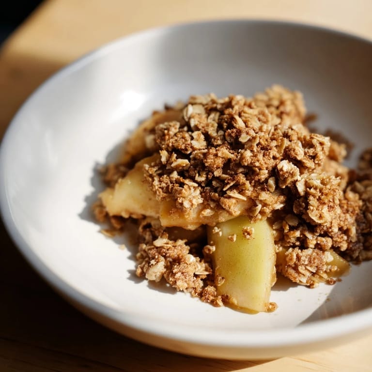A close-up view of Best Apple Crisp shows the tender apples beneath a crispy, irresistible topping.