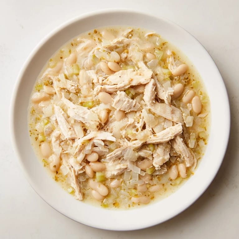 A close-up view of creamy 35-Minute White Cheddar Apple Chicken Chili, perfectly garnished and ready to be served.