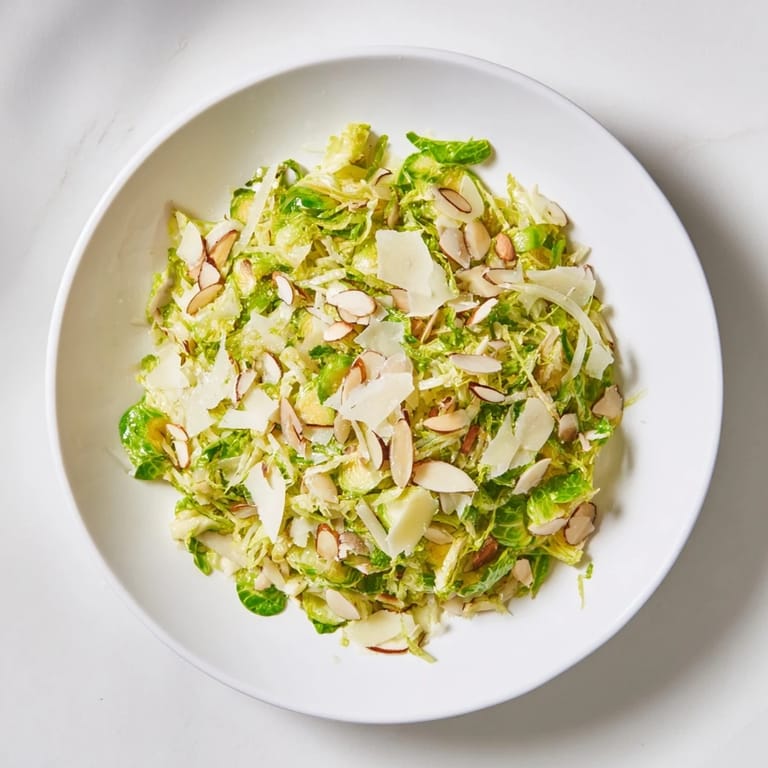 Tossed and ready: this zesty Crunchy Lemon Parmesan Brussels Sprouts Salad features crisp, shaved sprouts.
