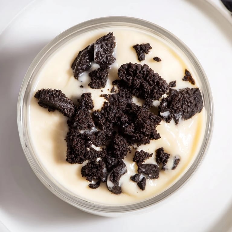 This vibrant photo shows a rich Vanilla Pudding with Crushed Oreos dessert, ready to enjoy.