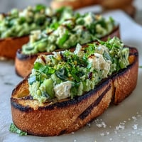Creamy fava bean and mint spread served on smoky grilled sourdough bread for a fresh spring appetizer.