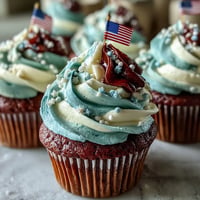 Star-Spangled Banner Cupcakes: Festive swirls of red, white, blue frosting and flag topper.